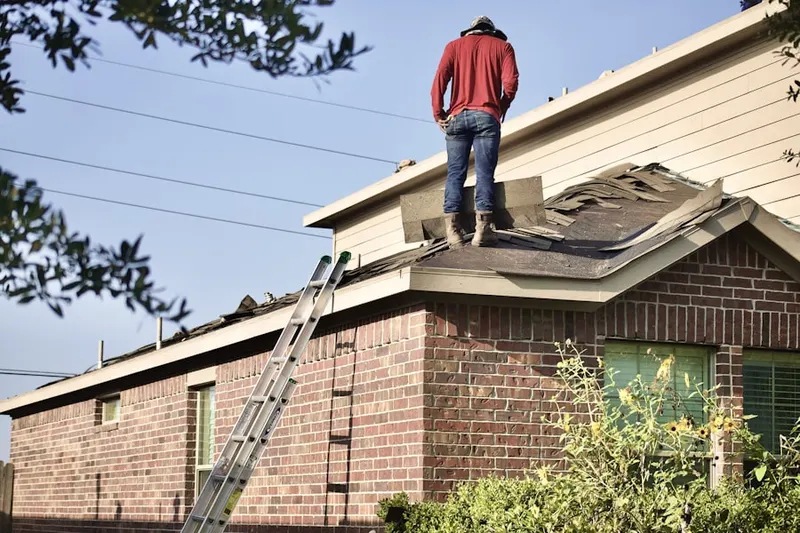 Professional roofer working on a residential roof in Shafter